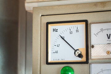 An electricity hertz rate indicator on the control panel of electric power generator machine....