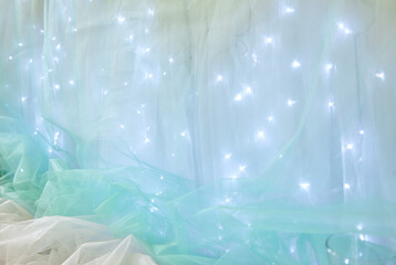 White and turquoise fabric. Glowing lights