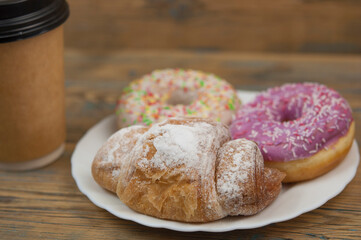 Glazed donuts on wooden background