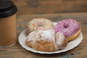 Glazed donuts on wooden background