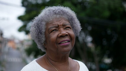 Portrait of an older woman face looking up at sky with HOPE and FAITH