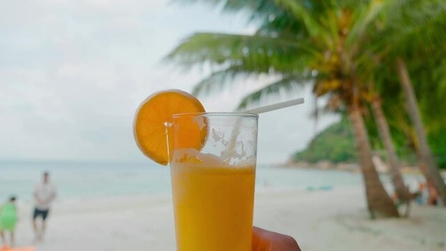 orange juce on the beach sea coast shore or orange fresh juice summer surf wave background refreshing drink relax positive mood vacation