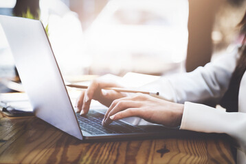 Young economists or accountants or financiers and investors are reviewing budget documents and using computers to study impact and risk assessments on corporate investment management.