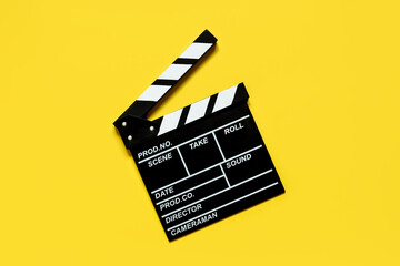 clapperboard for shooting video footage takes on a yellow background