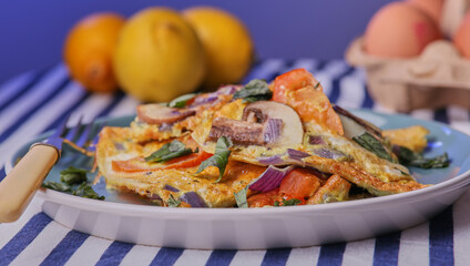 Italian frittata garnished with basil leaves.