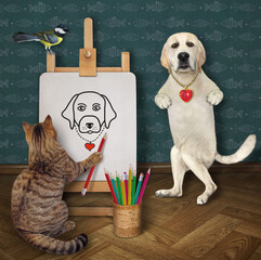 A beige cat artist with a pencil paints a portrait of a dog labrador on a canvas on an easel.