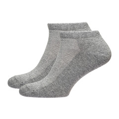A pair of fabric socks stands on a white isolated background. Volumetric socks on a transparent mannequin. Gray socks.