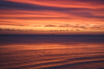 Abstract colorful sea background. Sea waves and beautiful colorful sky at sunrise.