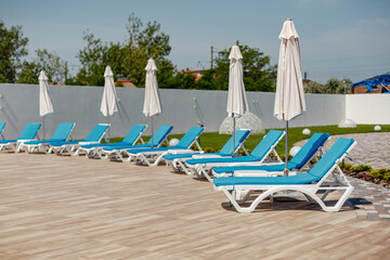 area near the pool with sun loungers and umbrellas