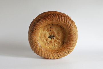 Uzbek bread from tandoor with raisin isolated on white background, patir, round bread.