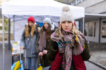 Depressed Ukrainian refugee woman crossing border and looking at camera.