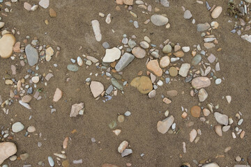 Stones in the beach sand. Good for backgrounds.