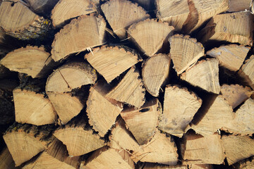 Neatly stacked firewood for kindling front view.