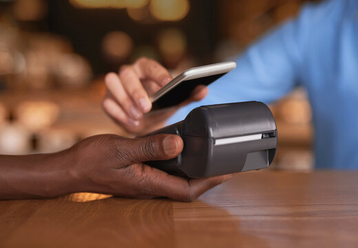 Tap To Pay. Cropped Shot Of An Unrecognizable Woman Making Payment In A Coffee Shop.