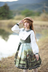A beautiful woman in lolita dress in garden background Japanese street fashion portrait