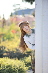 A beautiful woman in lolita dress in garden background Japanese street fashion portrait