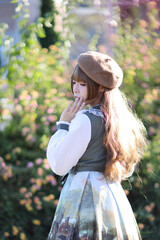 A beautiful woman in lolita dress in garden background Japanese street fashion portrait