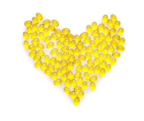 Heart shape made of yellow pills on white background
