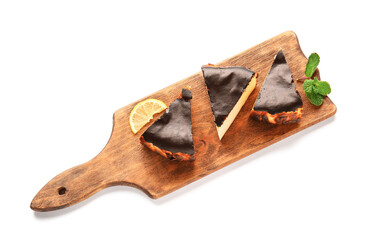 Board with slices of tasty Basque burnt cheesecake on white background