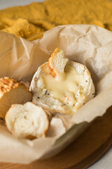 Camembert cheese baked in the oven with garlic sauce and spices. Homemade brie in the oven....