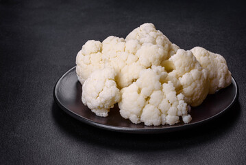 Beautiful swing of fresh white cauliflower on a dark concrete background
