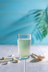 Collagen powder is add to glass of water with a spoon