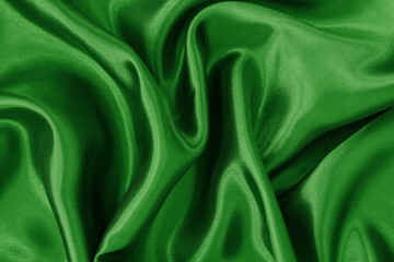 Dark green fabric cloth texture for background and design art work, beautiful crumpled pattern of silk or linen.