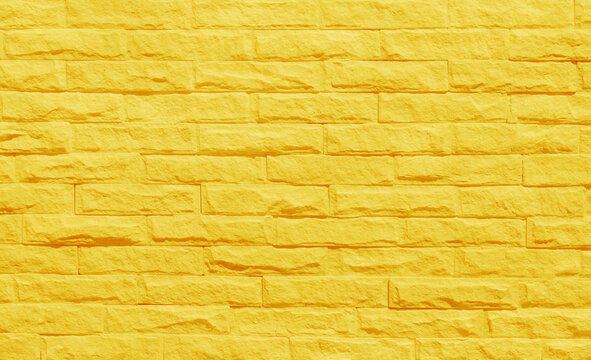 Golden yellow brick wall texture with vintage style pattern for background and design art work.