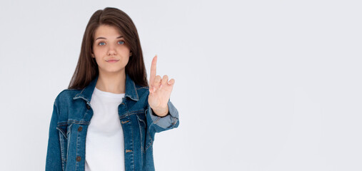 Portrait of a confident young woman showing stop gesture isolated over white background