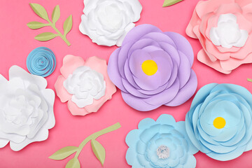 Beautiful handmade paper flowers on pink background, closeup