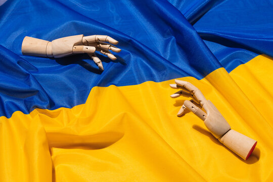 Wooden hand on Ukrainian flag