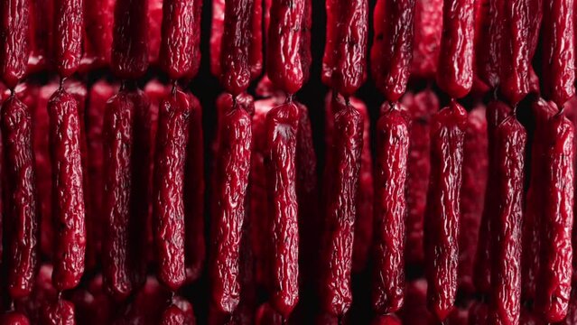 Smoked Beef Jerky links in the studio on black background.