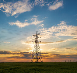 silhouette of power lines against the background of a cloudy sunset, saturated sky and pylons