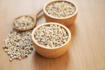 Fresh organic millet or job's tear seed on sack in bowl  in kitchen for cooking in daily life meal. selective focus. top view.