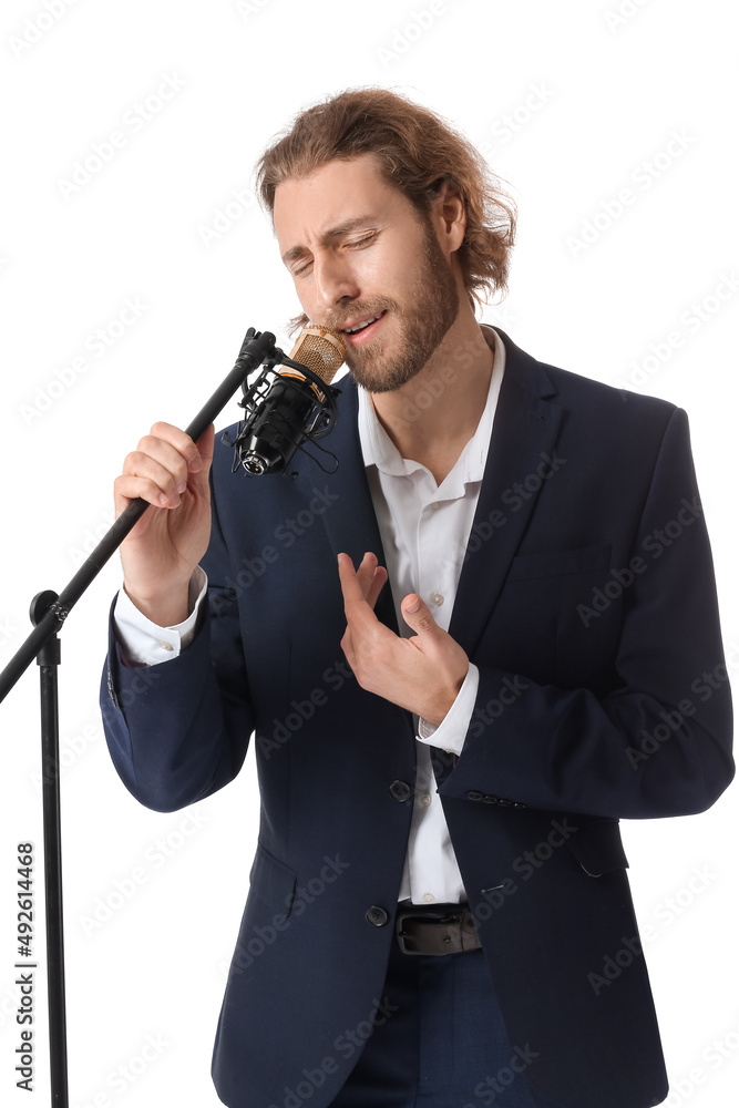 Canvas Prints Handsome young man singing in microphone isolated on white