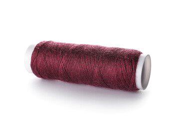 Red sewing thread spool on white background