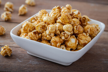 Popcorn with caramel in white bowl