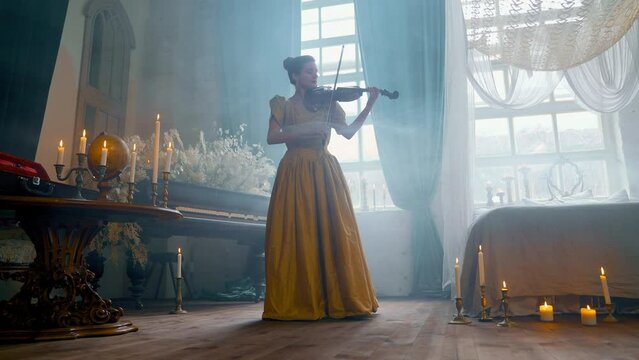 A Young Girl And Man Plays The Violin In A Beautiful Retro Room With Flowers And A Piano.  Beautiful Violin