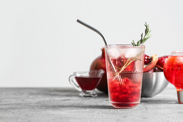 Glass of tasty pomegranate cocktail on table