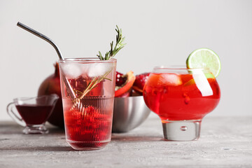 Glasses of tasty pomegranate cocktail on table
