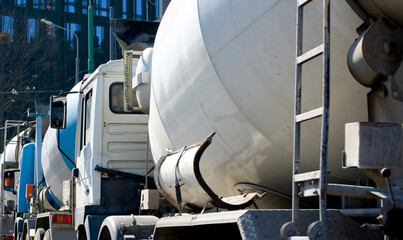 Cement mixers waiting in a row.