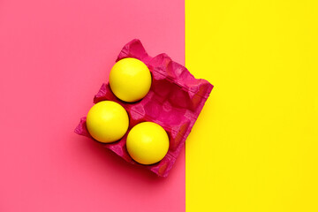 Holder with painted Easter eggs on color background