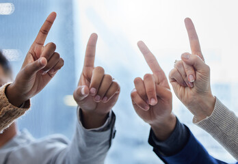 Bright ideas come to those who work. Shot of a group of businesspeople with their fingers raised. - Powered by Adobe