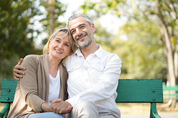 Fototapeta premium Portrait of happy elderly couple hug together, take care and love with good relationship, good health and romantic in the park, retirement insurance and lovely couple concept