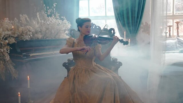 A Young Girl And Man Plays The Violin In A Beautiful Retro Room With Flowers And A Piano.  Young Girl.