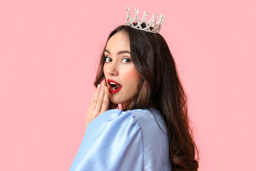 Beautiful surprised young woman in stylish dress and tiara on pink background © Pixel-Shot
