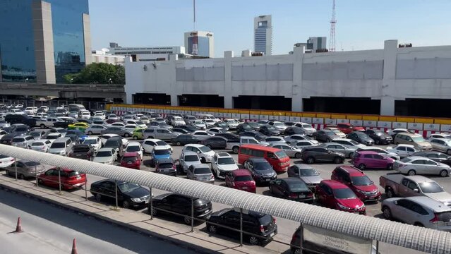 BANGKOK, THAILAND - Circa November, 2021: Parking lot at BTS Skytrain Public Transport Mo Chit Station, interchange station to Chatuchak MRT subway. - Panning shot on s sunny day
