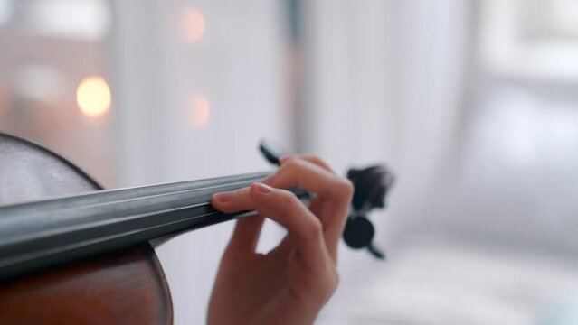 A Young Girl And Man Plays The Violin In A Beautiful Retro Room With Flowers And A Piano.