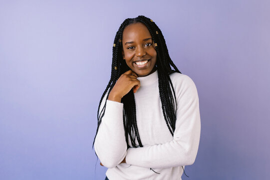 young smiling black woman in front of purple background