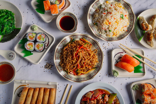 Asian food table with various types of Chinese food.